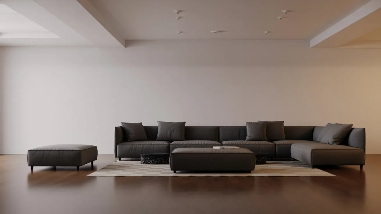 Modern living room with a sleek, dark gray sectional sofa, matching ottoman, and geometric rug on polished wood floors against a minimalist, white wall.